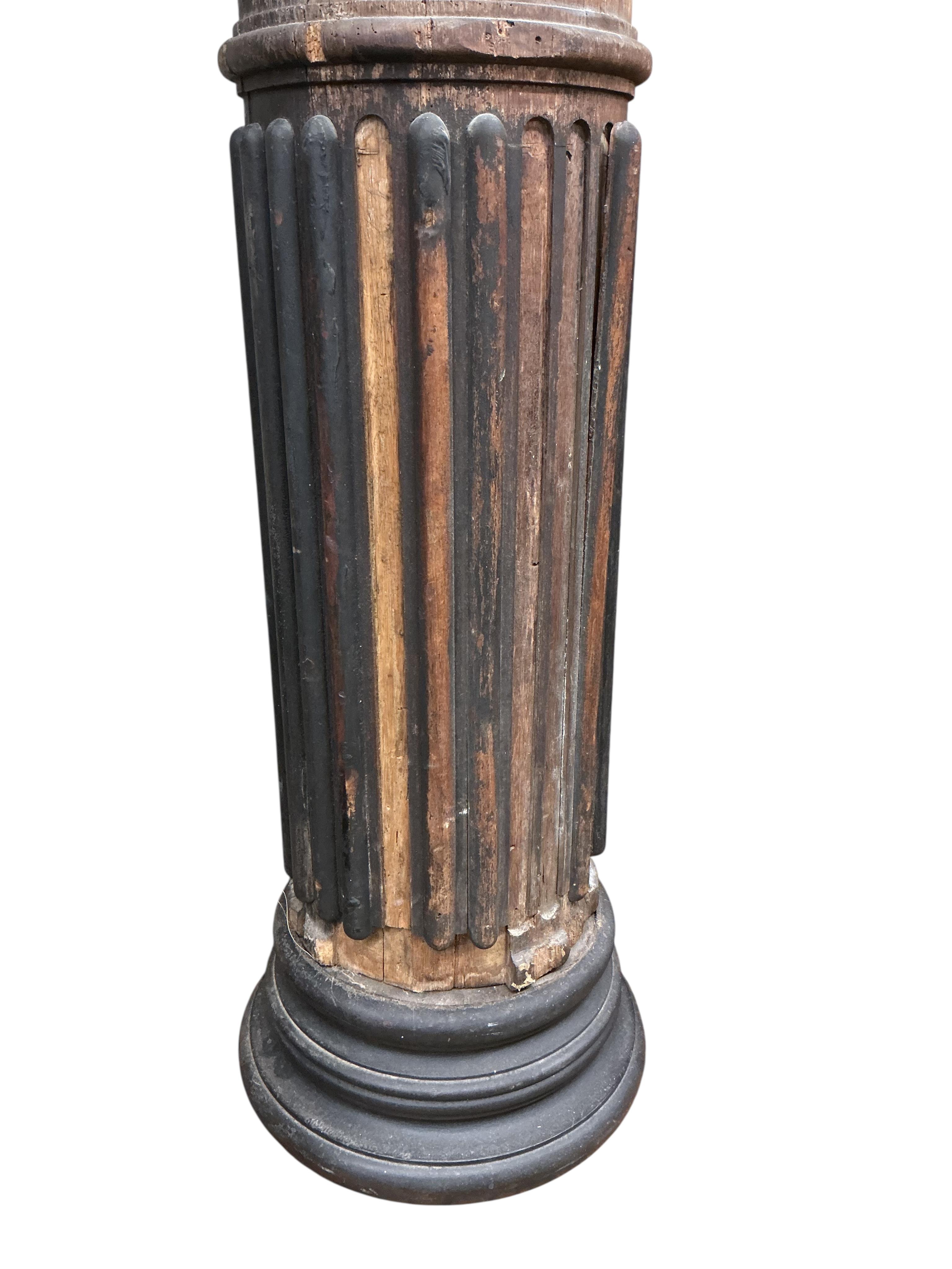 A pair of 17th century oak Corinthian columns, of large size, height 279cm, by repute from St Mary le Bow, designed by Christopher Wren